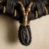 Image de Collier tribal torque médaillon gravé en ébène Ravok